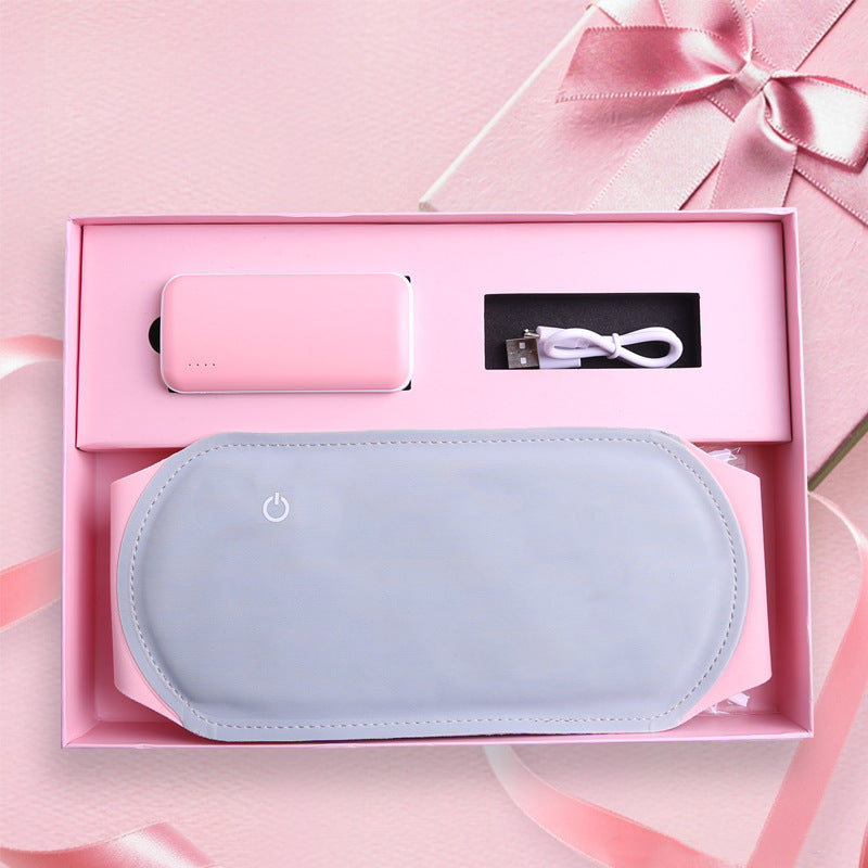 Cordless heated cramp relief belt wrapped around the lower belly