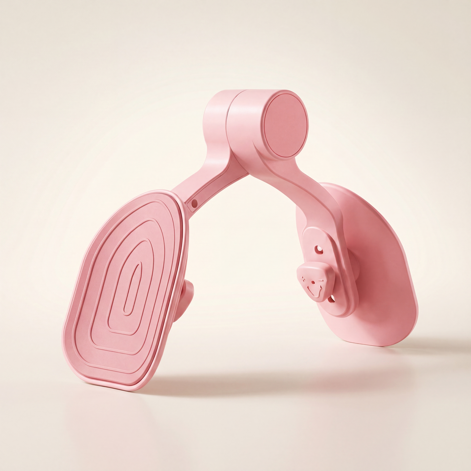 Pink inner thigh toner and leg exerciser on a clean warm off-white studio background